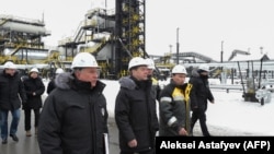 Russian Prime Minister Dmitry Medvedev (center) and Rosneft chief Igor Sechin (front left) inspect production facilities in Sibera on on November 21.