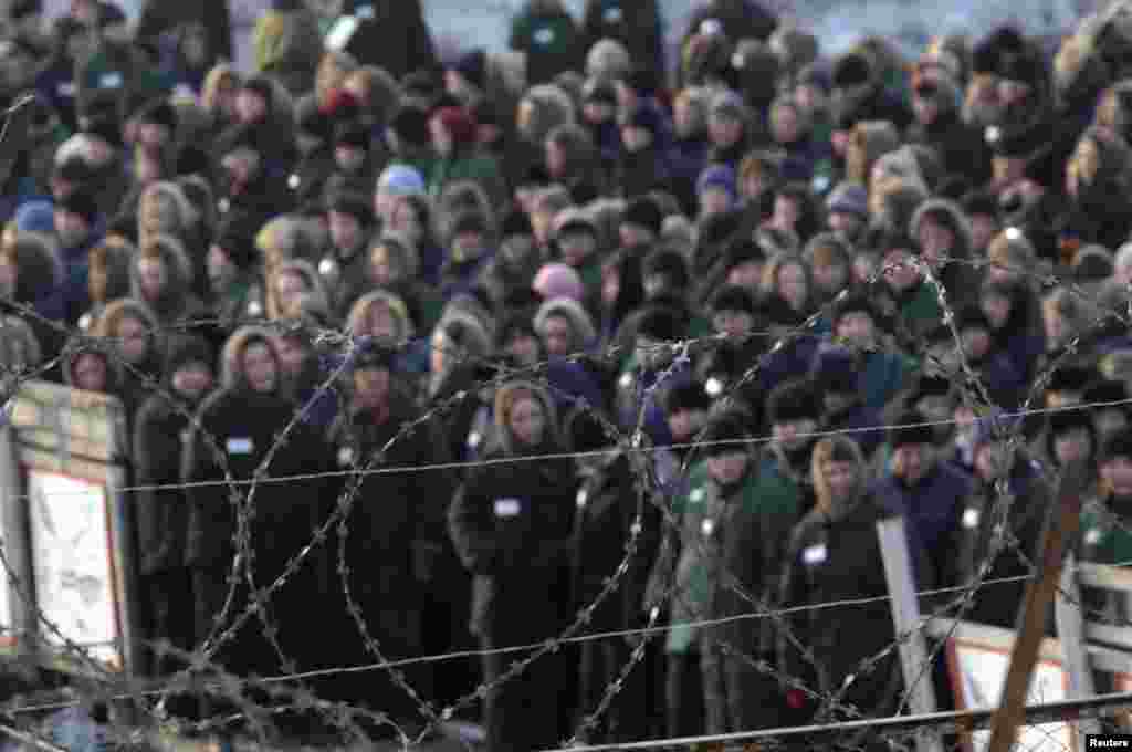 Inmates of a prison camp for women are seen through the razor wire before a &quot;Lady Spring 2009&quot; beauty contest in Selo Gornoye.