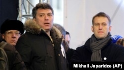 Boris Nemtsov (left) and Aleksei Navalny attend a rally to protest alleged vote-rigging in Russia's parliamentary elections in Moscow on December 24, 2011.