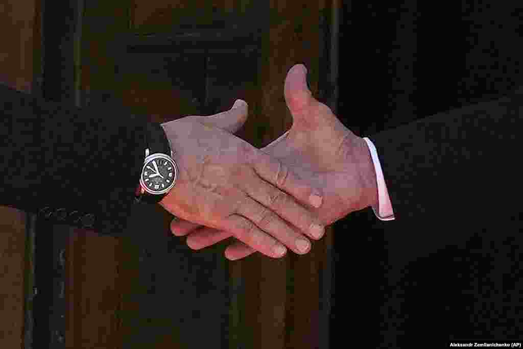 A close-up of a handshake between President Vladimir Putin (left) and President Joe Biden as they meet on June 16.&nbsp;