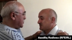 Musavat party deputy leader Arif Hajili (right) is greeted by an acquaintance in Baku after his release from prison on June 22.