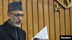 President Hamid Karzai gives an oath to members of the new parliament in Kabul last month. 