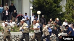 Supporters of the interim government assault the administration headquarters in Osh after it was seized by backers of ousted president on May 14.