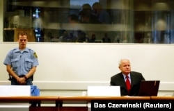 Former Yugoslav President Slobodan Milosevic opens his defense case at the Yugoslav war crimes tribunal in The Hague on July 5, 2004.