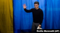 Volodymyr Zelenskyy waves to the media before casting his ballot at a polling station during the presidential election in Kyiv on March. 31.