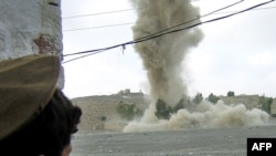 A tribesman watches an alleged hideout of insurgents being blown up during a military operation in Miranshah, North Waziristan, in 2006. Pakistan's military has mostly kept a truce with the region's warlords since a bloody offensive that year.