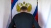  An oil worker marks his ballot in a voting booth in Russia's Tyumen region.