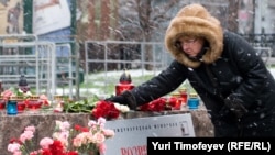 A woman pays tribute to the victims of Soviet repression on Lubyanka Square in Moscow.