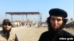 A screen capture from the Islamic State (IS) recruitment video showing a Tajik national (right) identified as "Abu Umariyon."