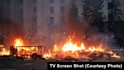 Dozens of people perished in a blaze apparently started by firebombs thrown inside a trade-union building in Odesa where pro-Russia activists had sought refuge amid street fighting with pro-Kyiv demonstrators. 