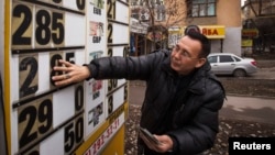 An employee changes an exchange rate at a currency exchange office in Almaty, Kazakhstan, in February.