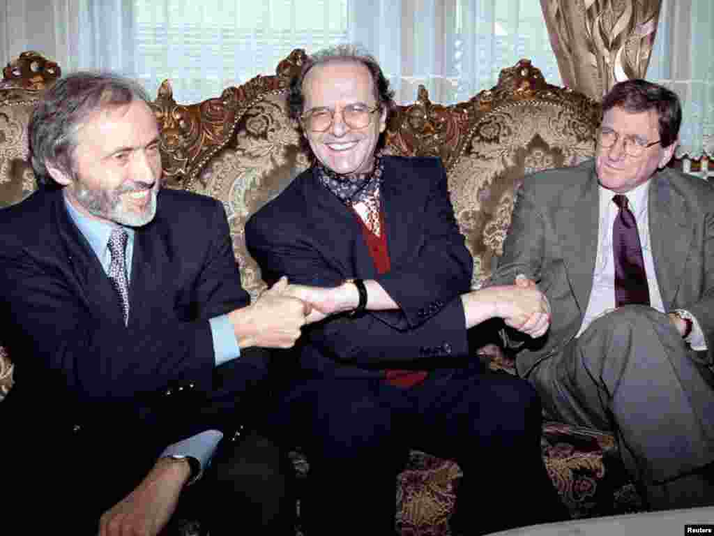 Ethnic Albanian leader Ibrahim Rugova (center) holds hands with U.S. envoy Richard Holbrooke and British Ambassador to Yugoslavia Brian Donnelly in Pristina on October 10, 1998.