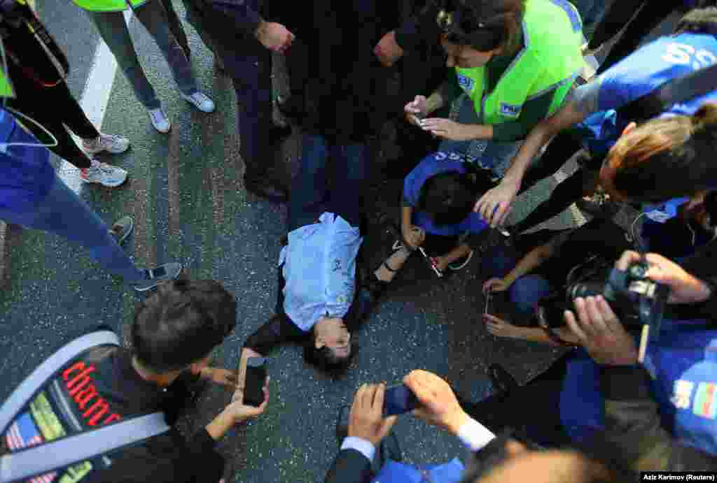 A woman lying on the ground after collapsing amid violent scuffles during the October 19 demonstration.