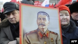 Russian Communist Party supporters hold a portrait of Soviet leader Josef Stalin at rally in Moscow in February.