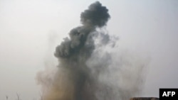 Smoke rises from the site of an air attack on a Taliban position northeast of Marjah.