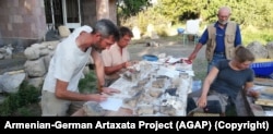 Some of the team works on finds in their "base camp" near the archaeological site of Artaxata.