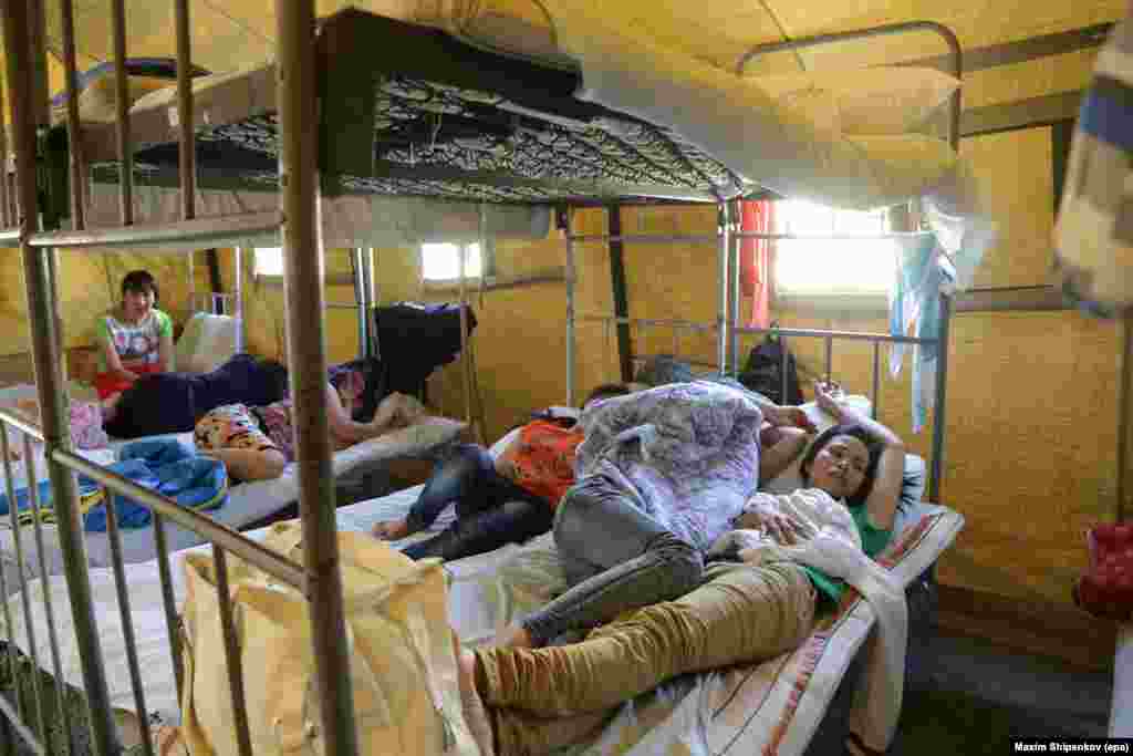 Illegal immigrants from Vietnam lie inside their tent at an immigration detention camp located in northeast Moscow in August 2013.&nbsp;