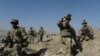 U.S. soldiers stand guard near the site of a suicide attack in Maidan Shar, the capital city of Afghanistan's Wardak Province, in September.