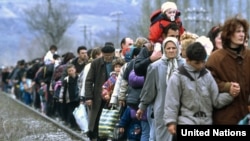 Kosovar refugees flee across the border into Macedonia in March 1999.