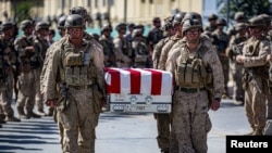 U.S. soldiers act as pallbearers for the 13 service members killed in a bombing at Kabul airport in August 2021. 