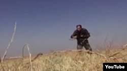 An video grab, published by Syrian rebels, that purports to show an Iranian soldier fighting in Syria.