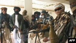 Taliban fighters pose in a mosque in Andar district of Afghanistan's Ghazni Province.