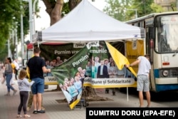 Supporters of the Party of Action and Solidarity (PAS) of President Maia Sandu at their electoral tent in Chisinau. Various scenarios include the PAS gaining an outright majority -- or falling just short and entering a coalition with Dignity and Truth.