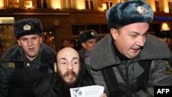 Russian police officers detain an opposition supporter during the "Day of Wrath" protest rally against government policy in central Moscow on November 12.