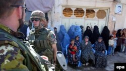 Italian ISAF soldiers stand guard during the launch ceremony of a girls high school, funded by the Italian PRT, in Herat in September 2009.