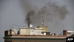 Black smoke billows from a chimney on top of the Russian Consulate in San Francsico on September 1. A fire department spokeswoman later told the Associated Press that the consulate had a fire going in the fireplace and that unidentified items were being burned.