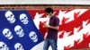 A man walks past a mural painted on the outer walls of the former U.S. Embassy in Tehran.