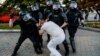 Belarusian police officers detain a demonstrator in Minsk during a protest on August 10, 2020, the day after a widely disputed presidential election. 