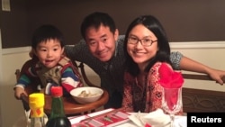 Xiyue Wang, a naturalized American citizen from China, with his wife Hua Qu and son