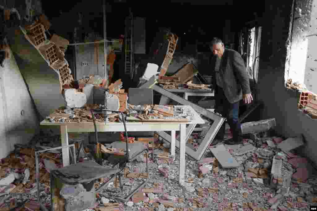 Ethnic Albanian Azem Ibrahimi visits his destroyed house in a neighborhood where a gunbattle took place between Macedonian police and an armed group in the town of Kumanovo.