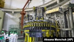 Personnel work to begin loading nuclear fuel at Belarus's first nuclear plant near Astravets on August 7.