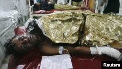 A man injured in the bomb blast in Nowshera awaits treatment at a hospital in Peshawar.