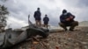 Members of a mine-clearing survey team examine unexploded items of ordnance in the war-torn Nagorno-Karabakh region earlier this month. 