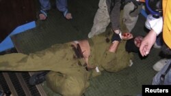 Pro-Palestinian activists hold down an Israeli commando on the Gaza-bound Turkish ship "Mavi Marmara." Nine Turkish nationals were killed when Israeli forces boarded the ship in international waters in 2010. 