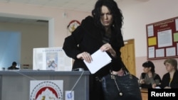 A woman casts her vote at a polling station in South Ossetia's Tskhinvali on March 25.