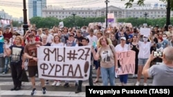 Protesters hold a banner reading "I'm/We're Furgal" as they attend a mass rally in support of Governor Sergei Furgal in Khabarovsk on July 16.