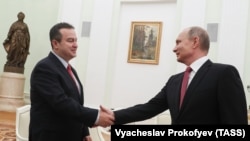 Serbian Foreign Minister Ivica Dacic (left) and Russian President Vladimir Putin meet at the Kremlin in Moscow in December.