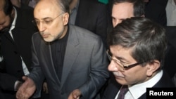 Iranian Foreign Minister Ali Akbar Salehi (left) with his Turkish counterpart, Ahmet Davutoglu, in Tehran on January 4.