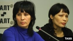 Bakiya Kasymova (left) and Leila Ashirova, both recently freed from captivity, talk to reporters in connection with a recent "slavery" scandal involving migrant workers in Moscow.