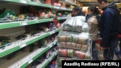 When news of the Central Bank's decision reached the streets, people across Azerbaijan rushed to shops to scoop up whatever they could before prices adjusted to the new reality.