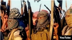 A screen capture from an IS propaganda video on YouTube shows IS fighters near Tikrit, in Iraq.