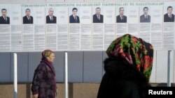 A billboard in the capital, Ashgabat, displays the portraits and biographies of the country's eight presidential candidates.