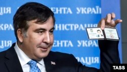 Former Georgian President Mikheil Saakashvili shows off his identification card as the head of an advisory council in Kyiv in February.