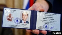 Valentin Gorbunov, the head of Moscow's City Election Commission, holds the candidate registration certificate of Aleksei Navalny at the Moscow mayor's office on July 17.