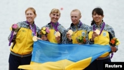 Gold medallists (left to right) Kateryna Tarasenko, Yana Dementieva, Anastasiia Kozhenkova, and Nataliya Dovgodko of Ukraine pose during the victory ceremony after the women's quadruple sculls Final A at Eton Dorney during the London Games on August 1.