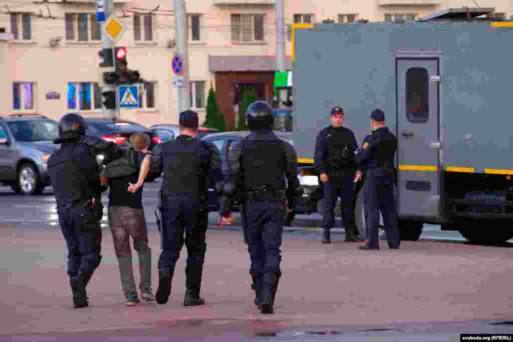 Another man is taken to a police van in Vitsebsk.